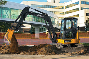 John Deere compact excavator operators can now switch buckets without leaving the cab thanks to the new hydraulic coupler.