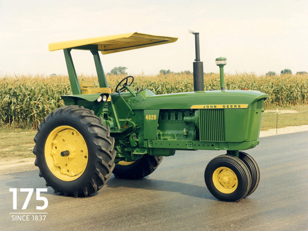 A red agricultural tractor with flaming neon wheels rushes on like a racing  car through puddles of spray. concept for the sale of agricultural tires,  agricultural machinery and tractor racing ai Stock