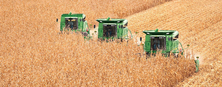 Farm image of a John Deere row crop tractors during harvesting season