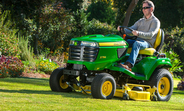 <img src=“X754.jpg” alt=“Man cutting lawn with John Deere X754 steering mower with yellow chute attachment”>