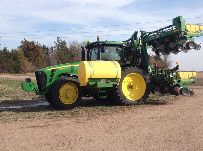 John Deere tractor pulling folded planter