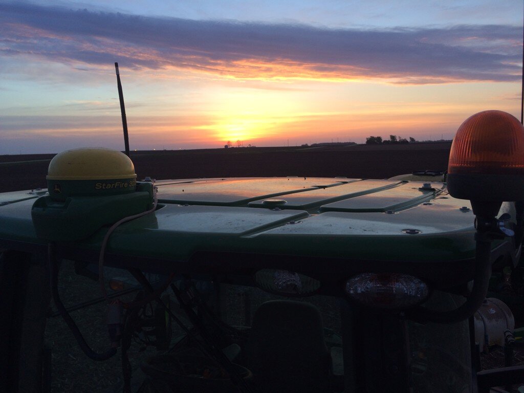 John Deere tractor cab sunset