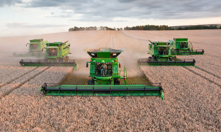 john deere combines in the field