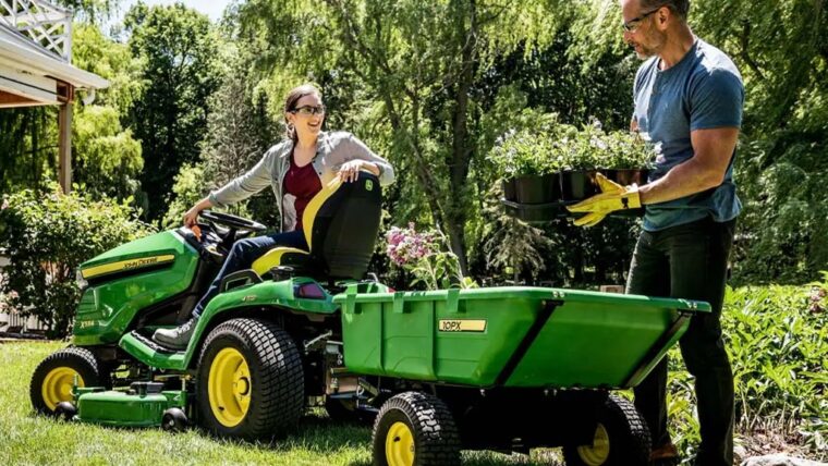 John Deere 10PX poly cart attached to lawn tractor during yard work