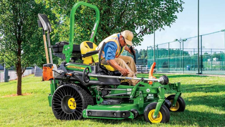 Man operating a John Deere Z930M zero-turn mower