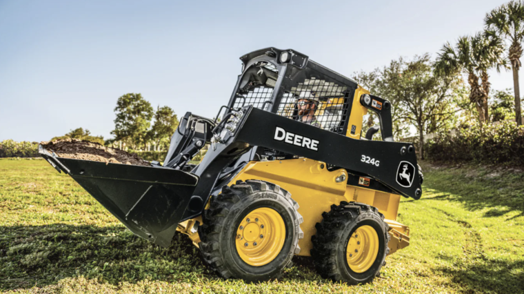 John Deere skid steer in a field