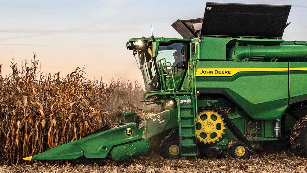 Corn harvest underway with a John Deere combine, aligning with trends in the USDA Crop Progress Report.