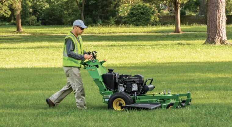 Operator using a John Deere W48M on grass