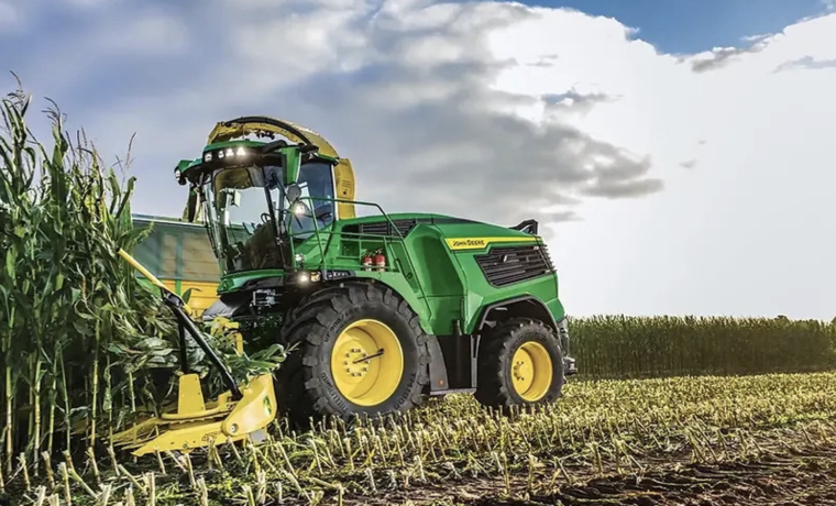 John Deere forage harvester working in a field. 