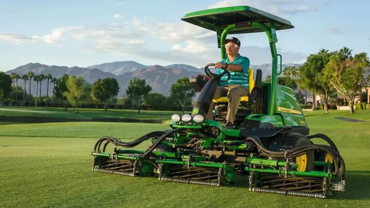 John Deere fairway mower operating on a golf course with reel cutting units mowing closely maintained turf.