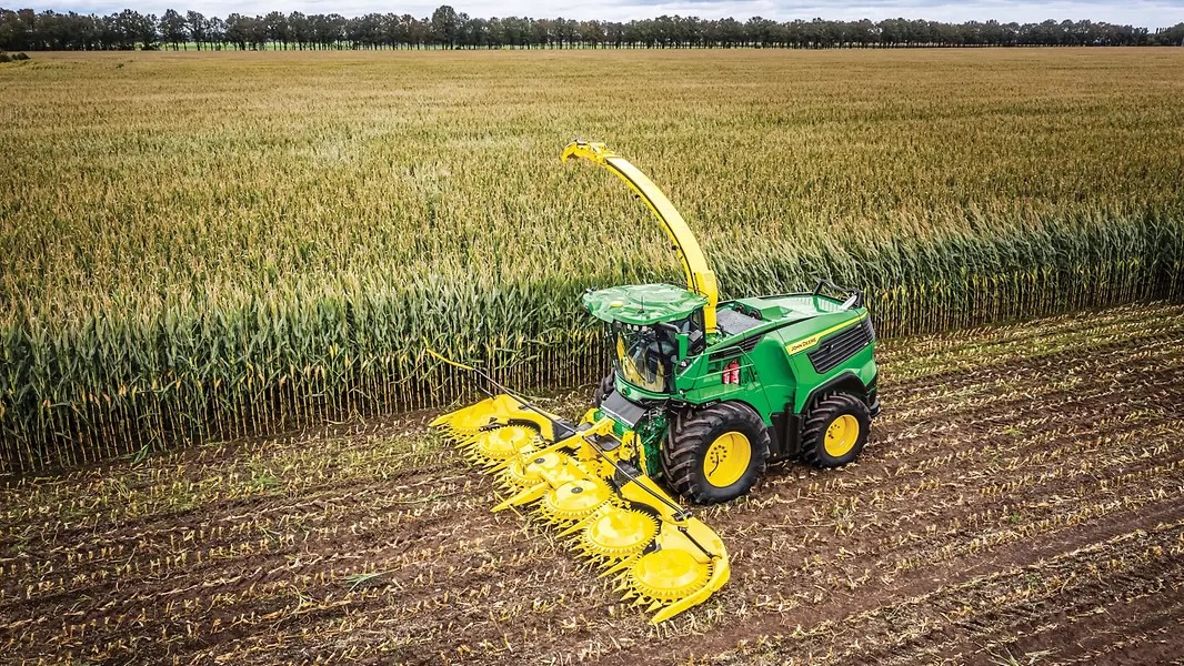 John Deere forage harvester working in a field.