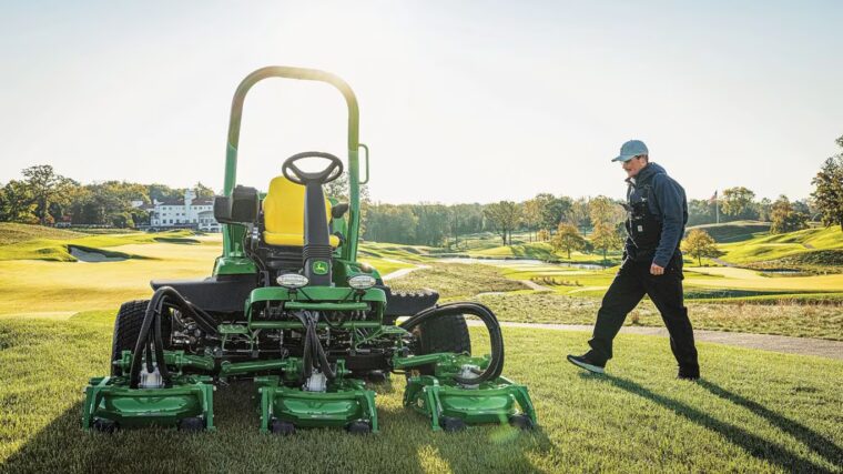John Deere rough, trim, and surrounds mower on a golf course with multiple cutting decks.